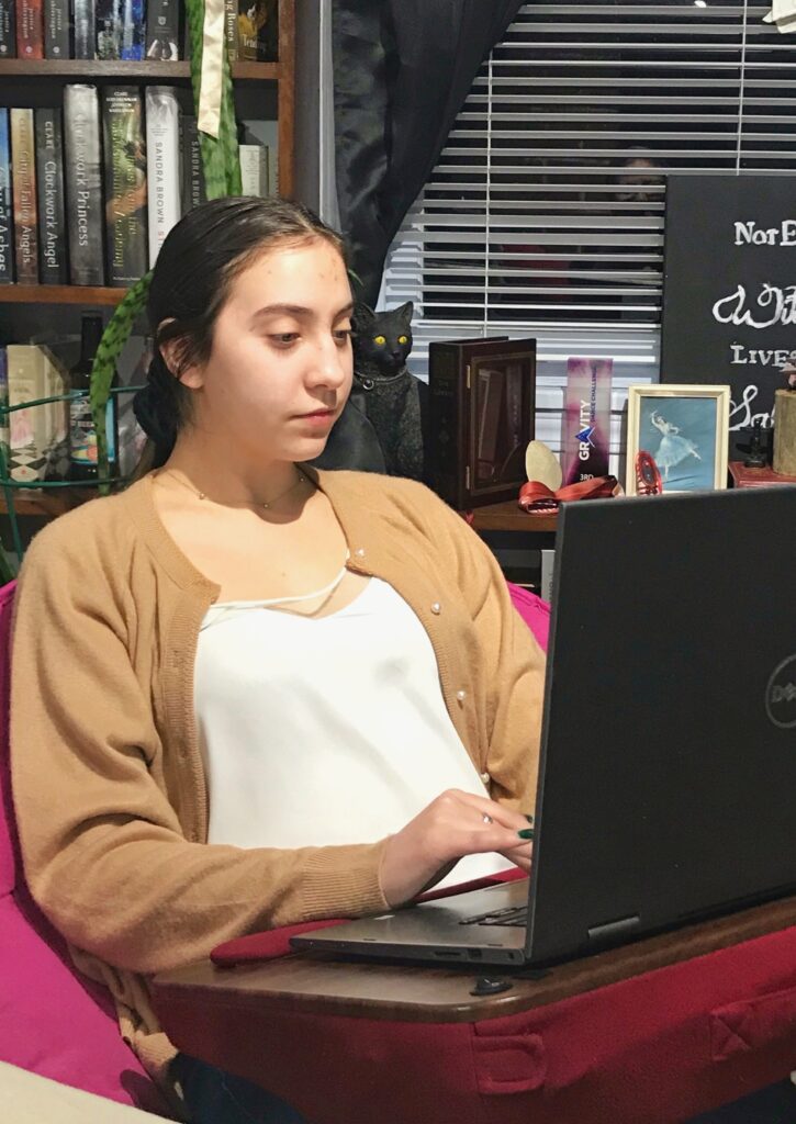 High school student, Mackenzie, works on her laptop in isolation during Covid-19 quarantine